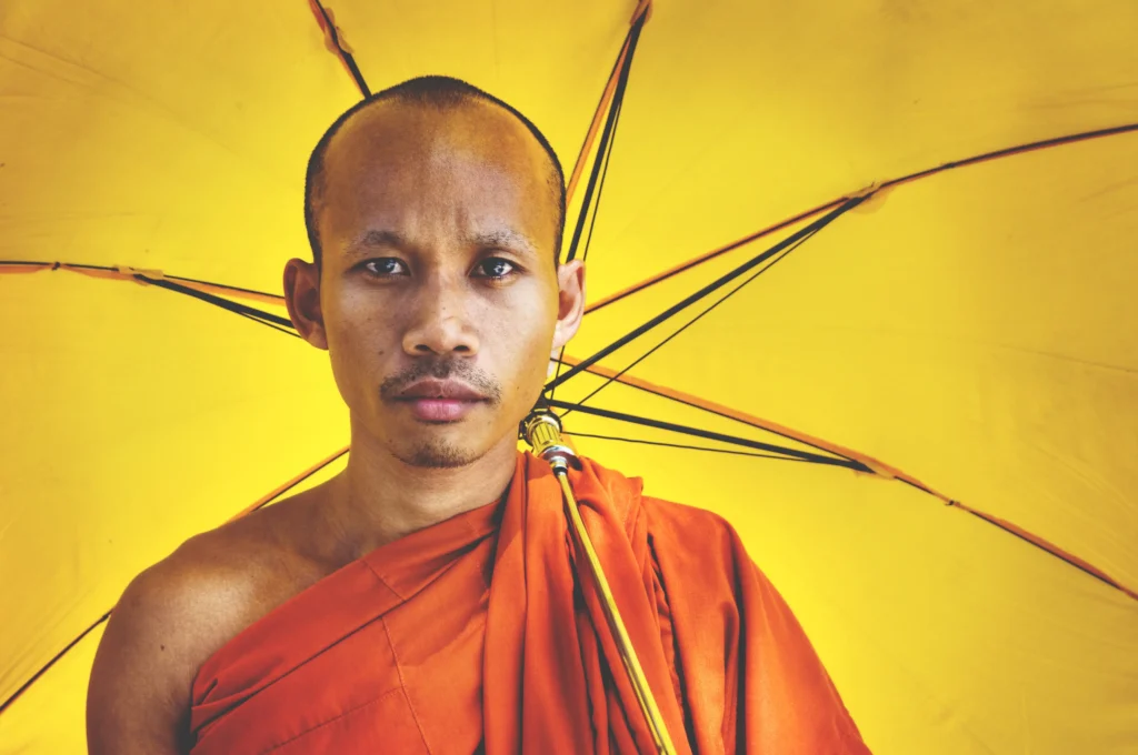 buddhist monk holding umbrella ceremony concept