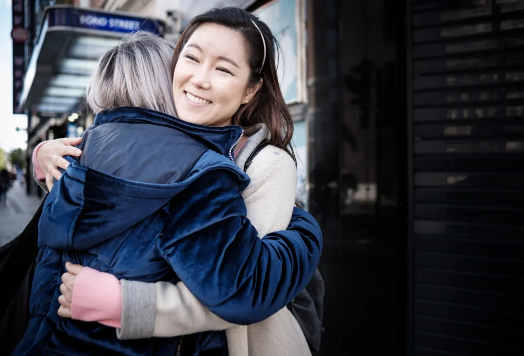 multiracial mature women friends hug each other