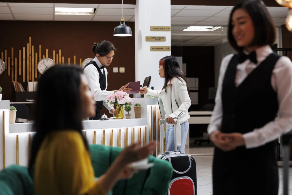 receptionist checking tourist passportr